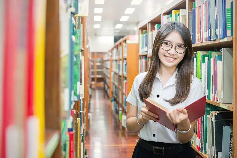 Female college student inside the library