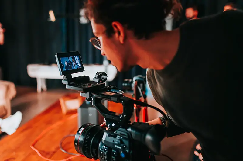 photo of a man holding a video camera