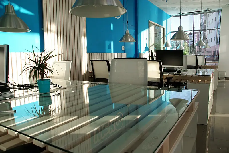 Office space with white chairs and glass table