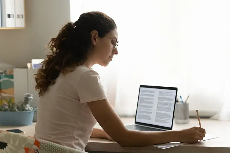 Female interpreter translate document on her laptop