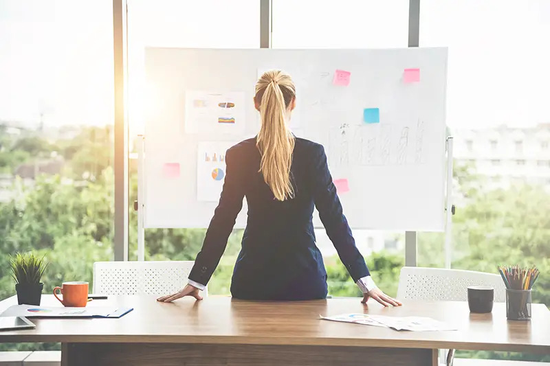 Woman staring at the future plan board