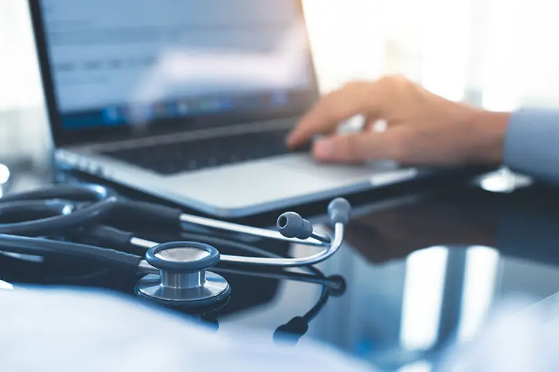 Male doctor hand working on laptop computer