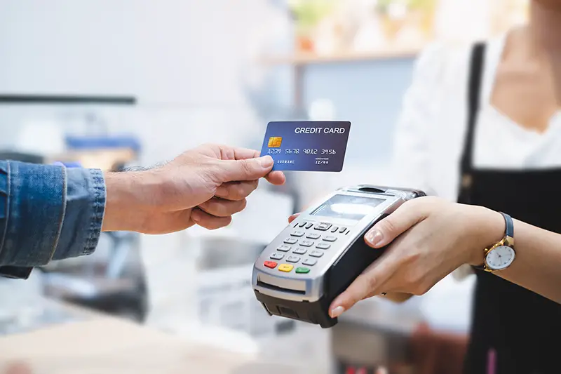 Customer using credit card for payment to owner at cafe restaurant