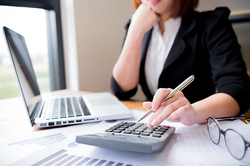 Asian female accountant making calculations