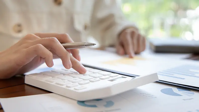 Woman accountant using white calculator