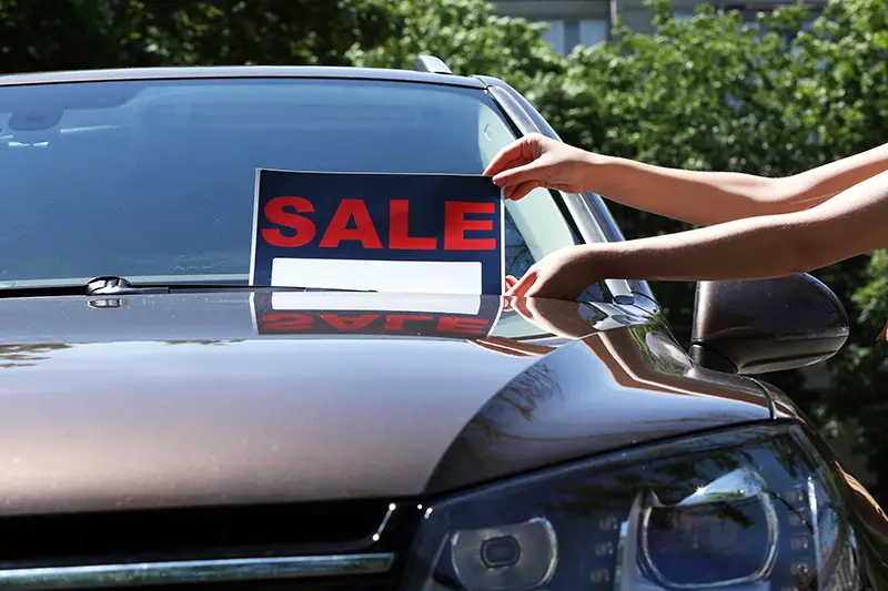 For sale sign on windshield of car