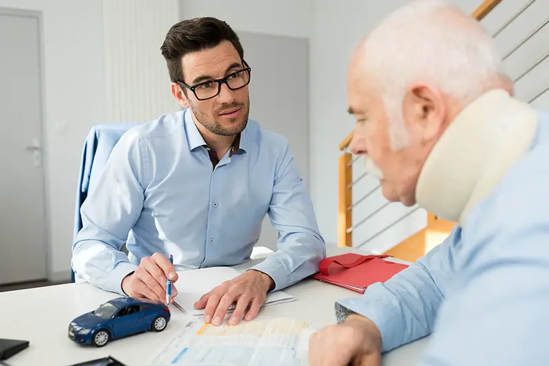 personal injury lawyer in meeting with client wearing neck brace