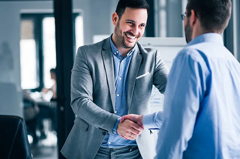 Businessmen making handshake in the office