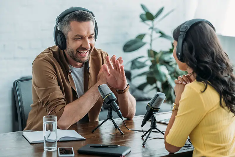 Man and woman talking in a podcast