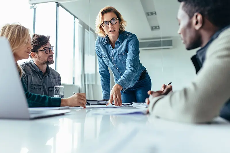 Businesswoman standing and leading business presentation. Female executive putting her ideas during presentation in conference room.