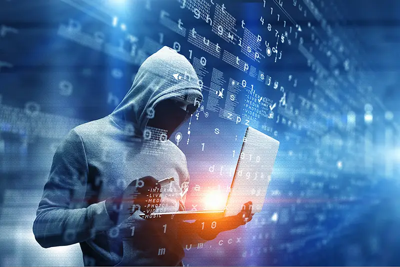Hacker man with laptop in hands 