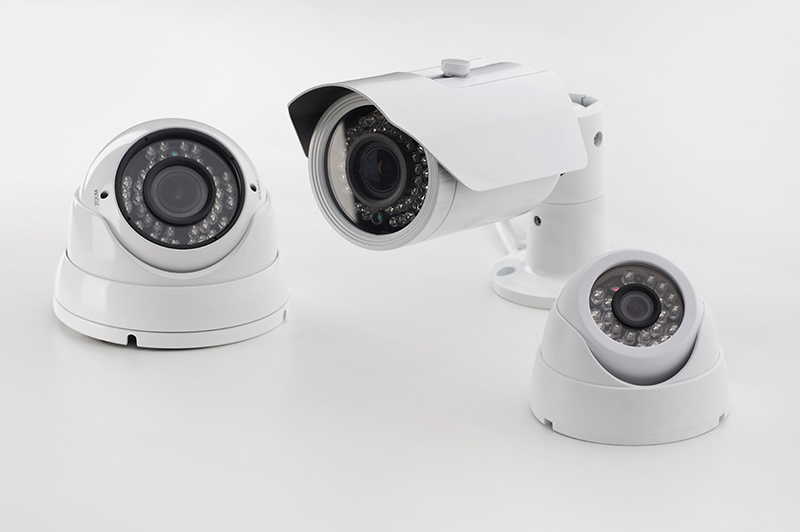 Bullet style and dome secure cameras on light background, surveillance cameras