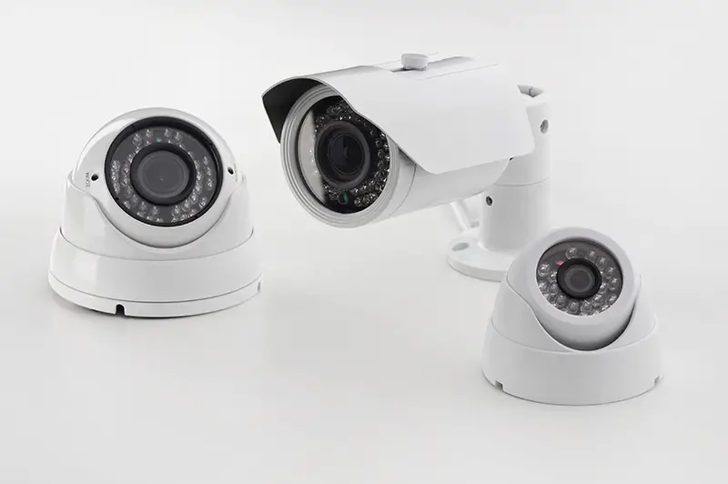 Bullet style and dome secure cameras on light background, surveillance cameras