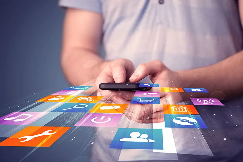 Man holding smart phone with colorful application icons comming out