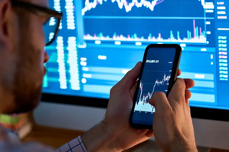 Business man trader investor analyst using mobile phone app analytics for cryptocurrency