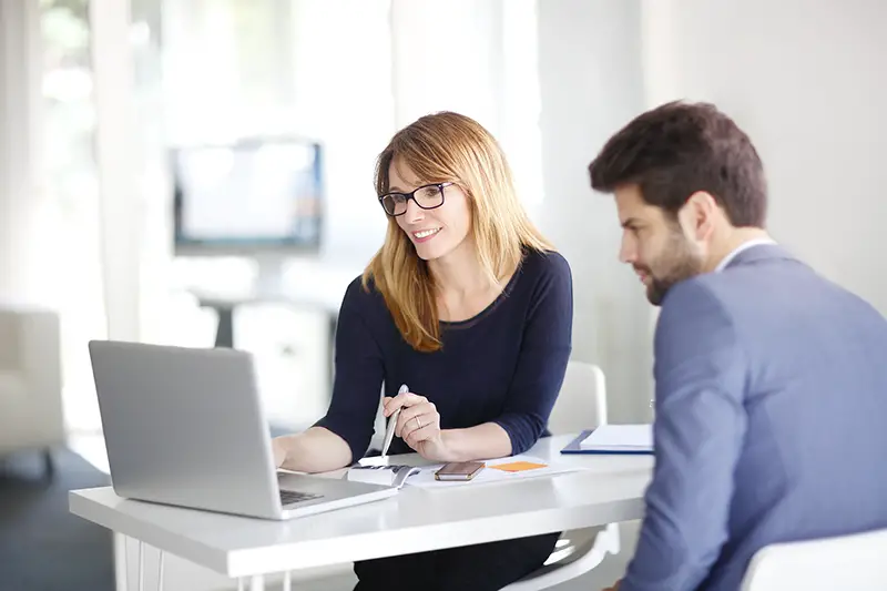 Professional woman property advisor talking to a young man client