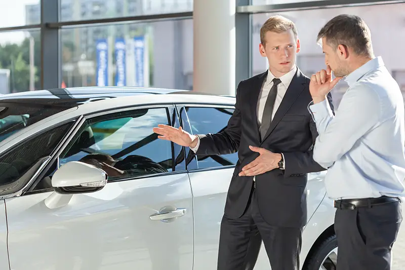 Car seller talking to a male customer