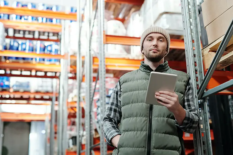 man in bubble jacket holding a tablet