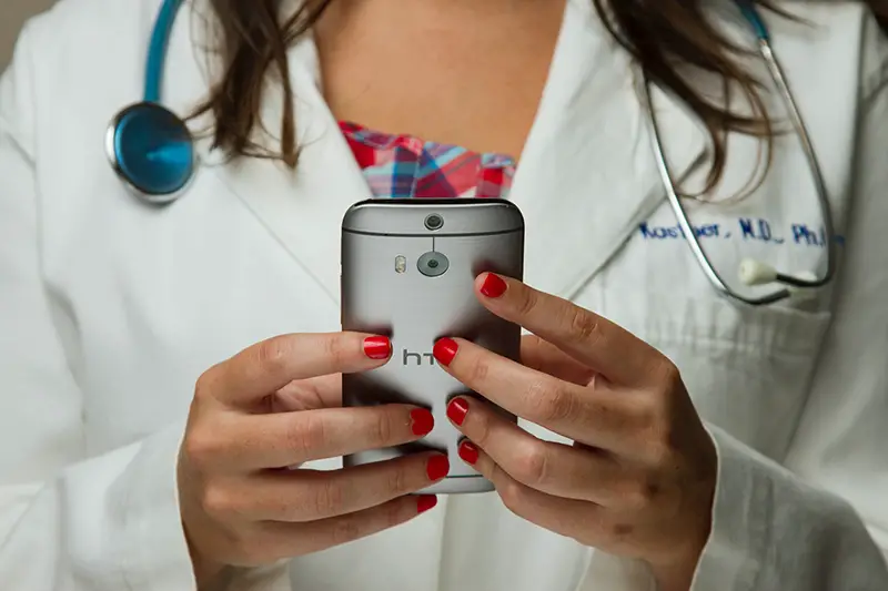 Doctor Holding Cell Phone