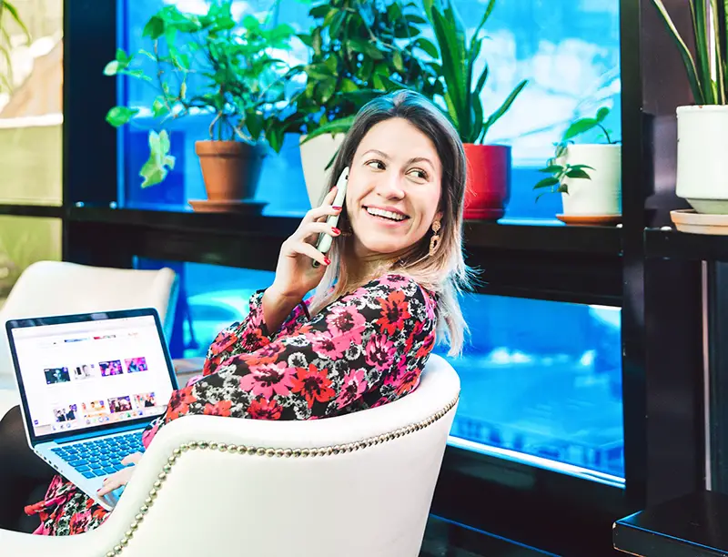 Woman smiling while talking on mobile phone