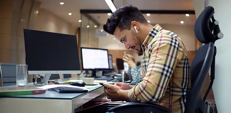 Man wearing headset while using his smartphone