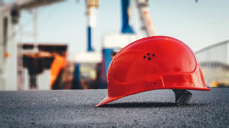 Red hard hat on pavement