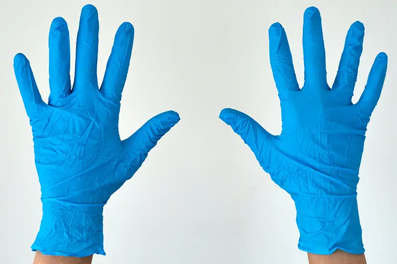Person wearing blue gloves