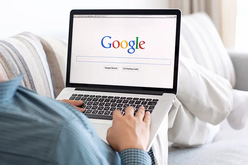 Person using laptop browsing on google