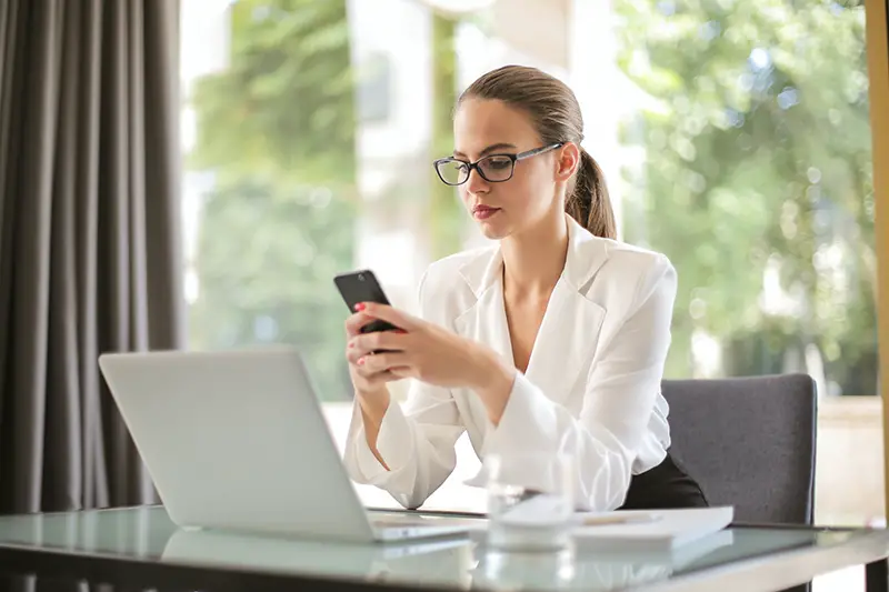 businesswoman using smartphone in workplace