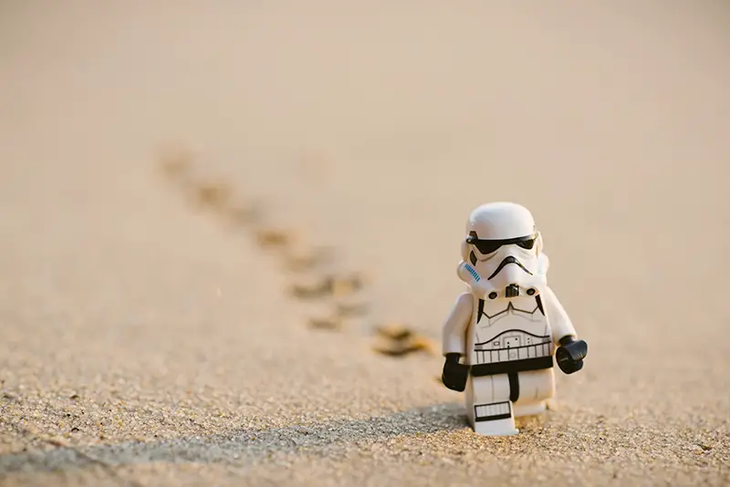 stormtrooper minifigure walking on the sand