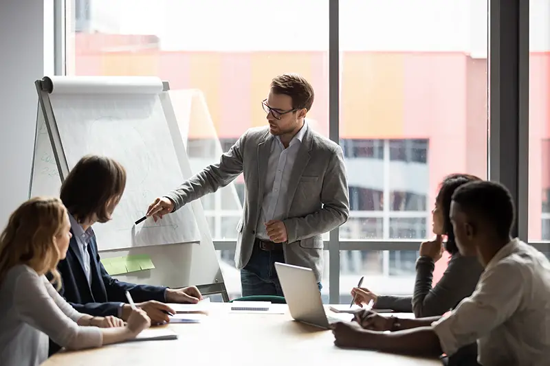 Business leader having a team meeting inside the office