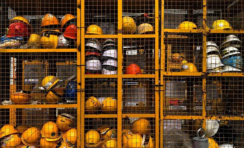 Construction helmets in yellow metal storage