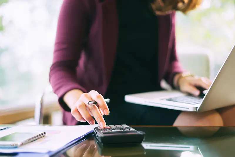 Businesswoman using black calculator