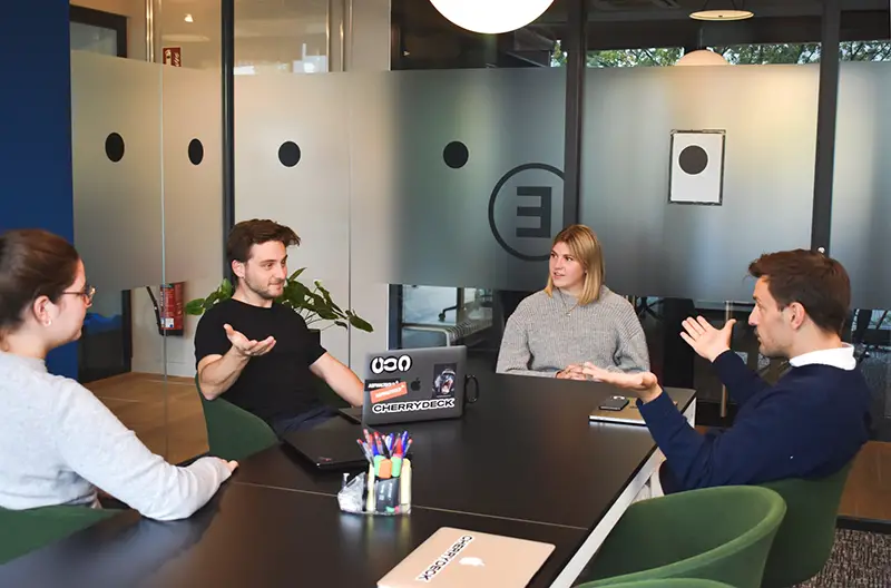 Group of people talking inside the office