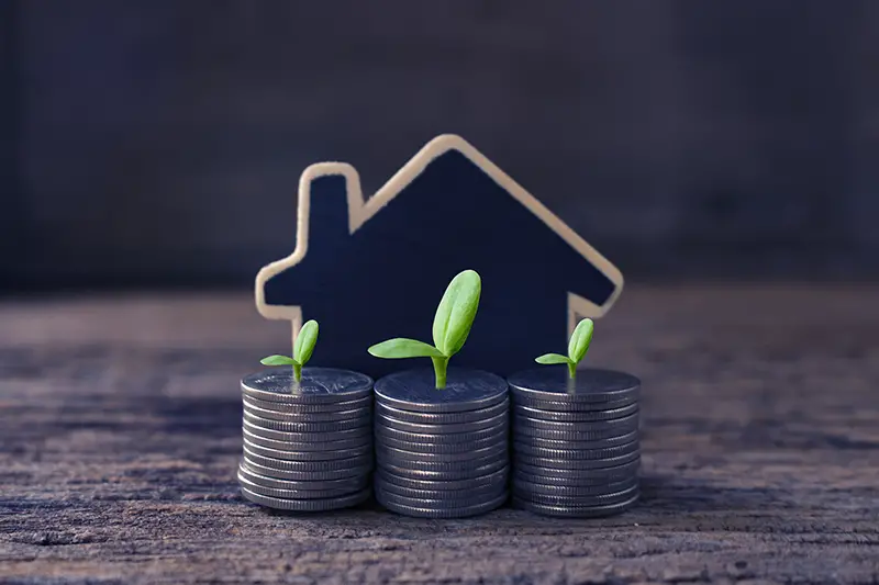 stack coins and house wood model