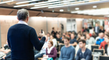 Man talking in front of people