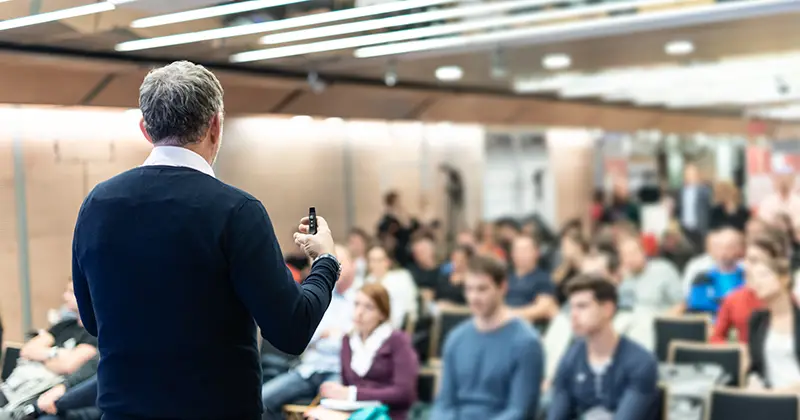 Man talking in front of people