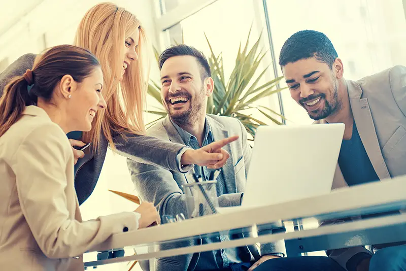 Group of business people in front of laptop