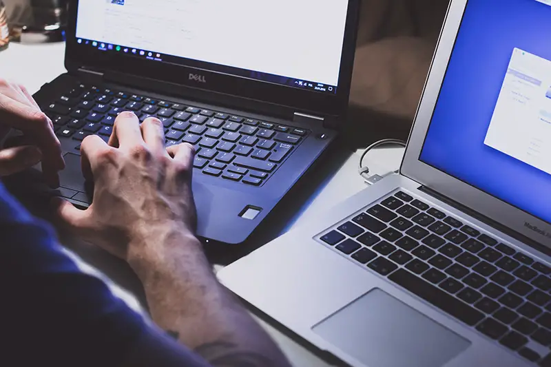 Person using black laptop computer