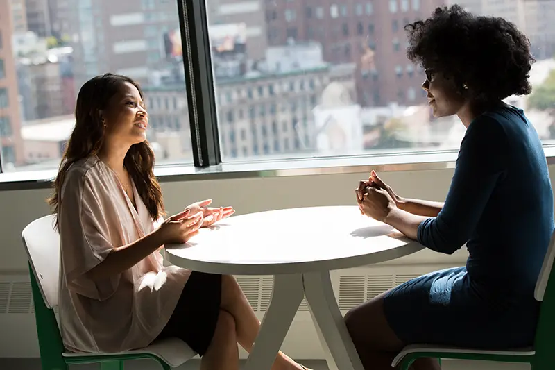 photography of women talking to each other