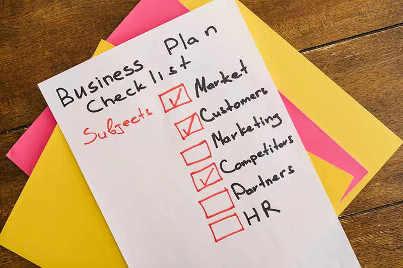 Business plan checklist on a white piece of paper