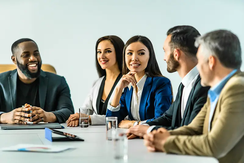 The five business people sitting at the table