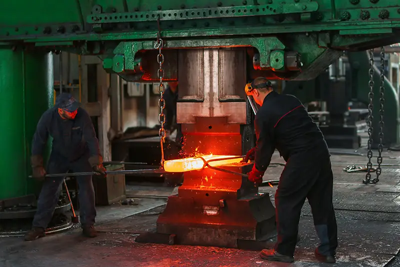 two men holding two grey metal tools