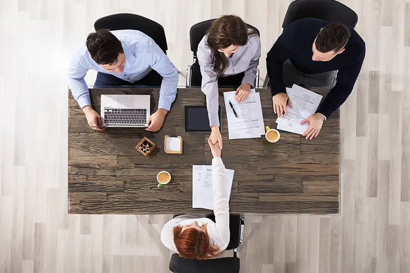 Group Of Corporate Recruitment Officers Shaking Hand With Candidate