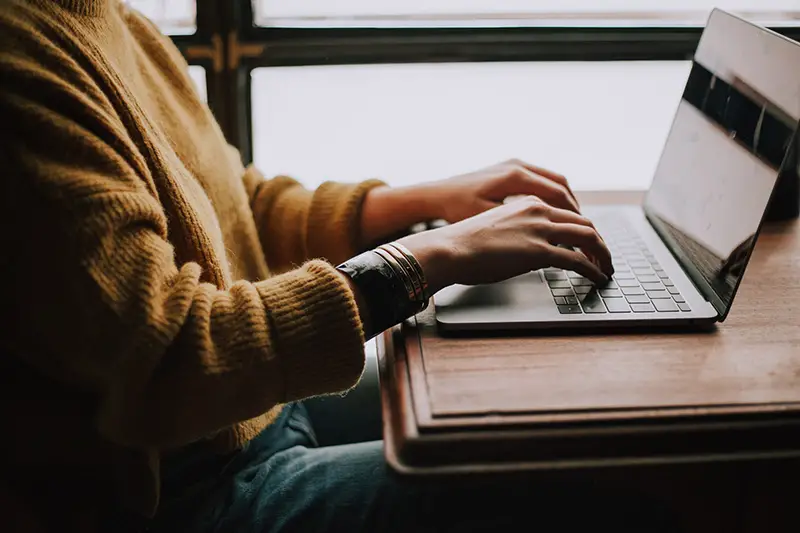 Person sitting in front of laptop