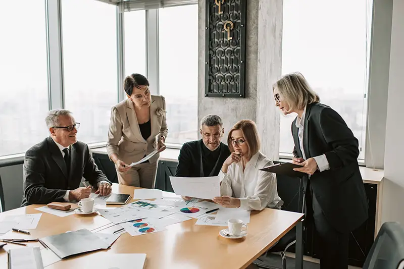 Group of business people working near brown wooden table