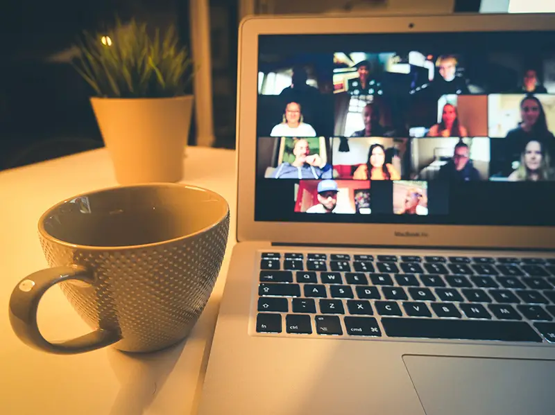 Macbook displaying people in virtual events