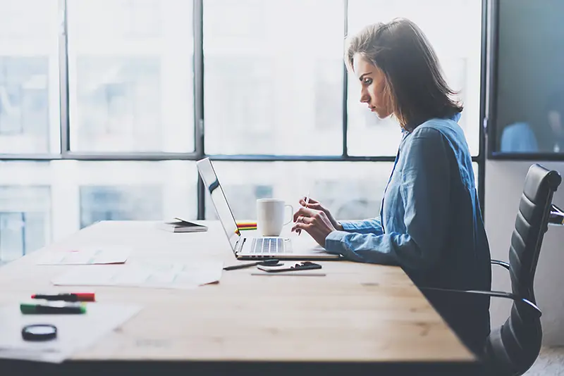 Woman sitting in front of her laptop