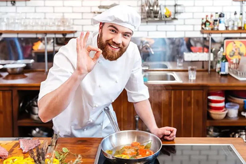 Male chef cooking on his kitchen