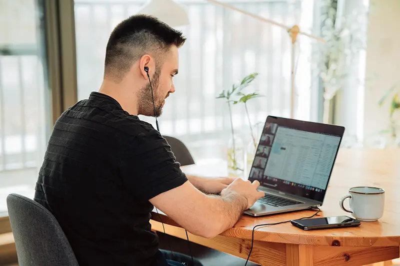 young man working in home office and having a meeting conference